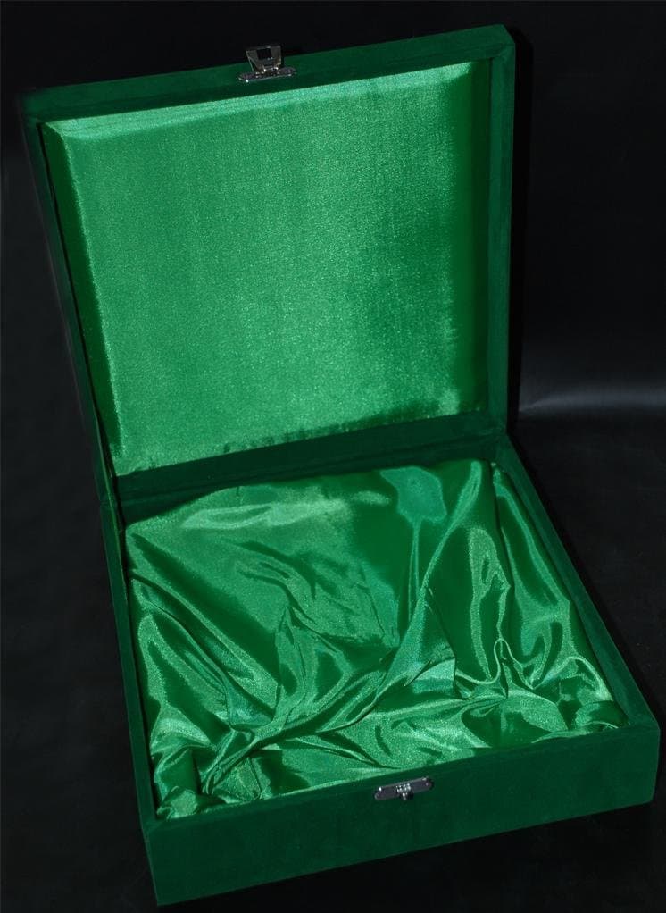 Open green velvet presentation box with folded green satin-like lining