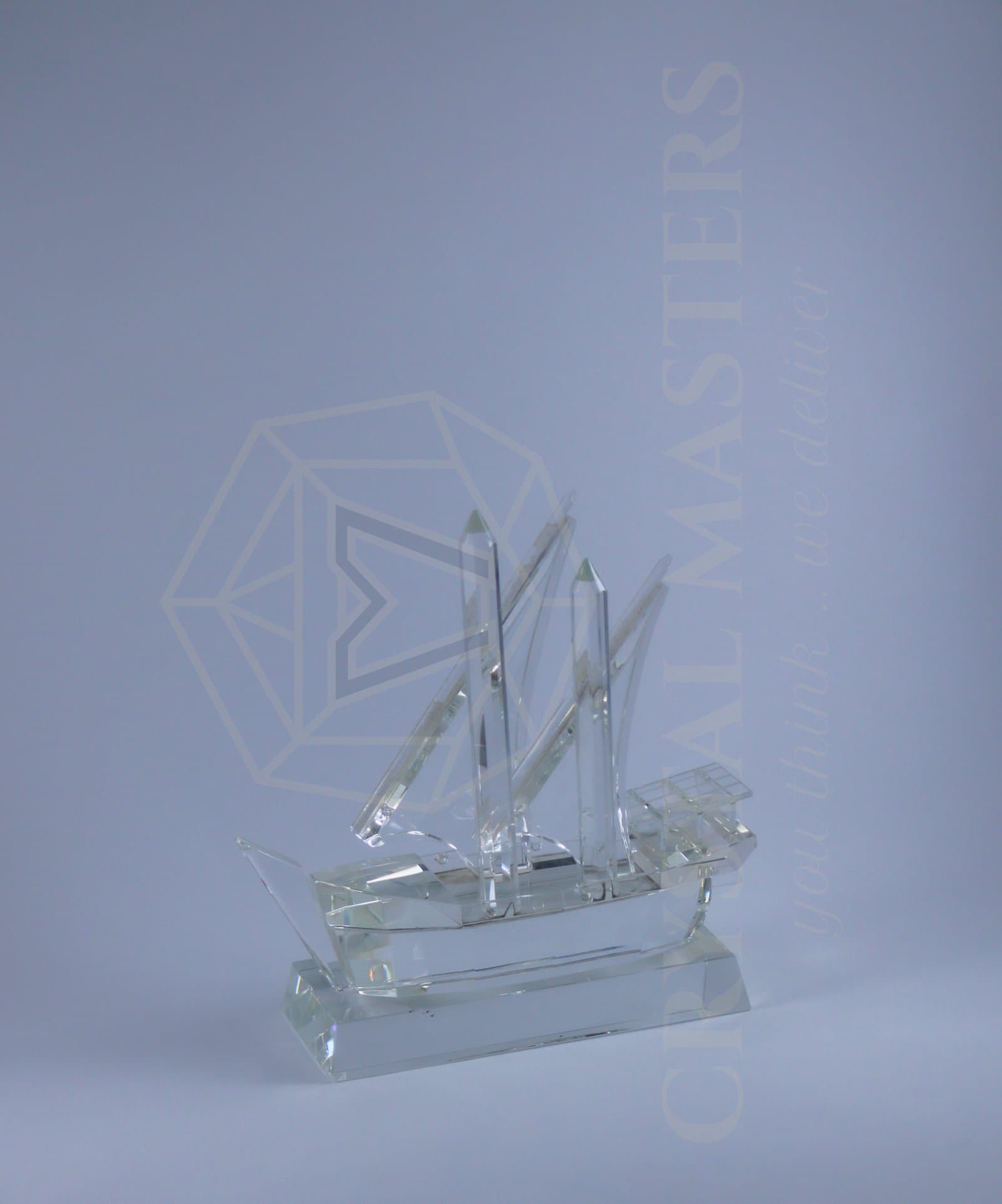 Clear sailing-dhow miniature with triangular sails, fine masts and a transparent display base