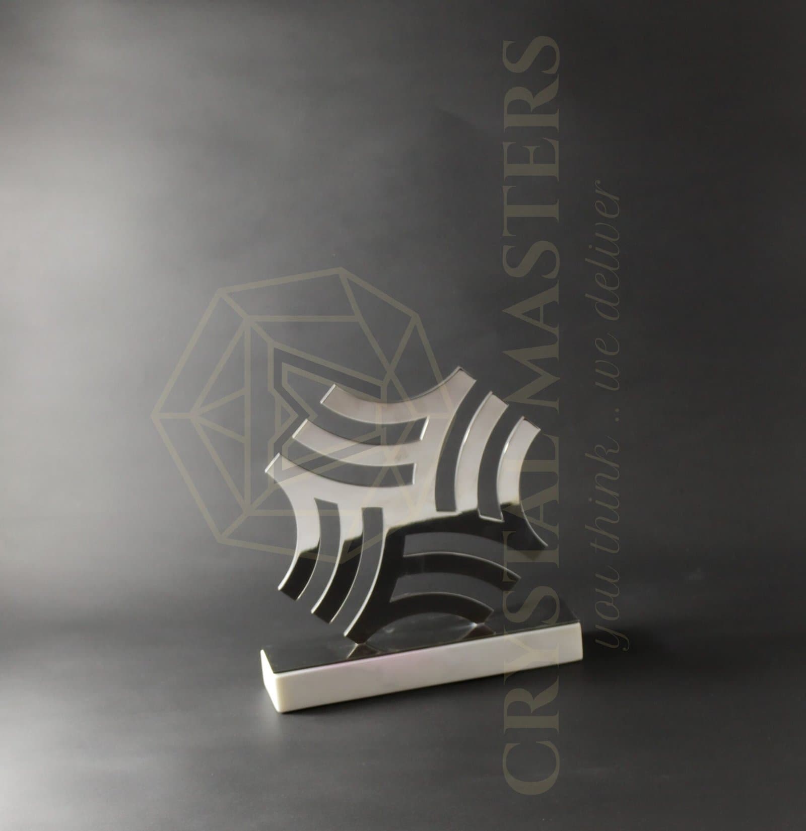 Geometric metal award with interwoven light and dark curved bands on a low pale-edged base