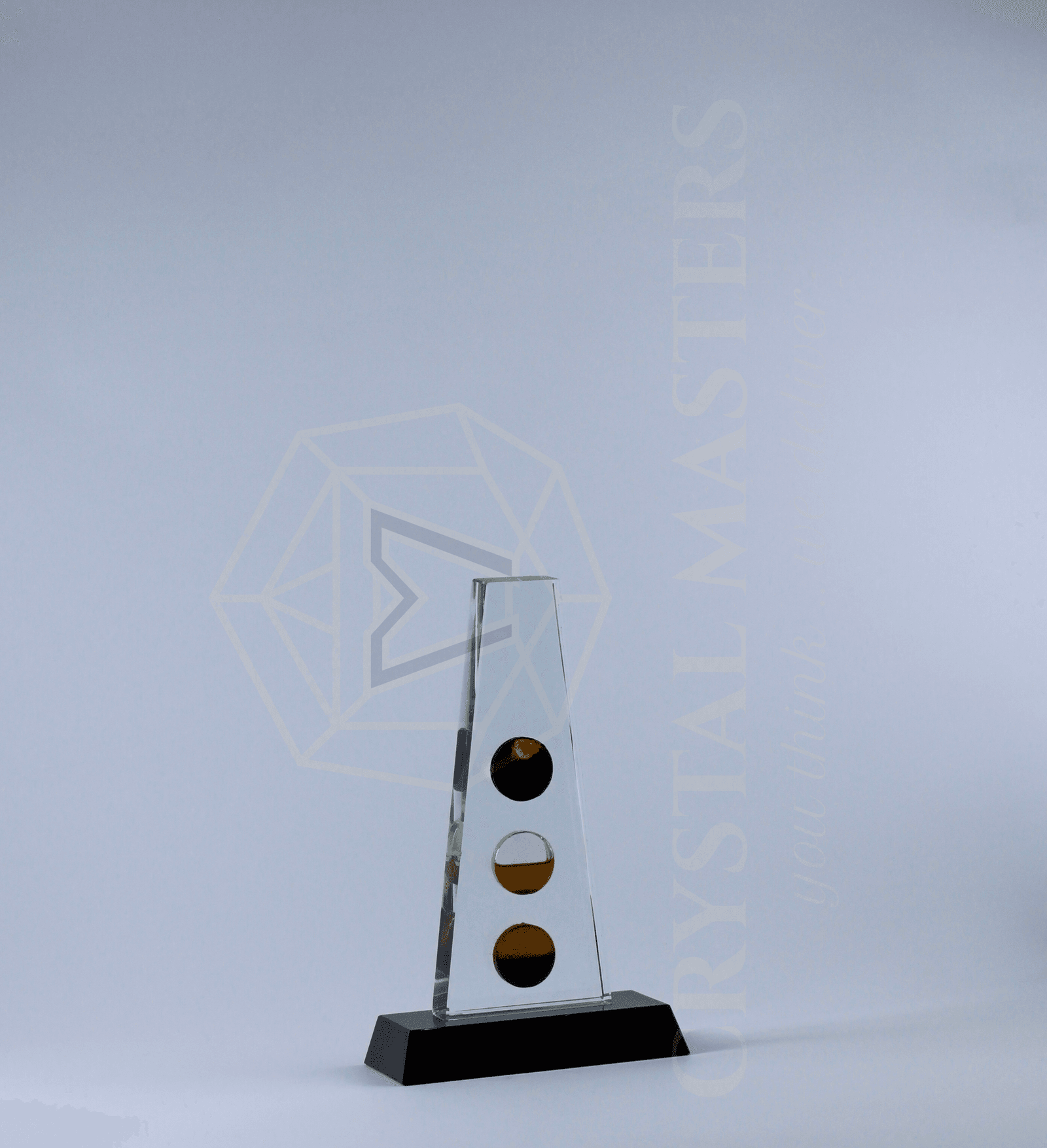 Tall narrow clear plaque with vertically arranged gold-toned circular accents on a dark base