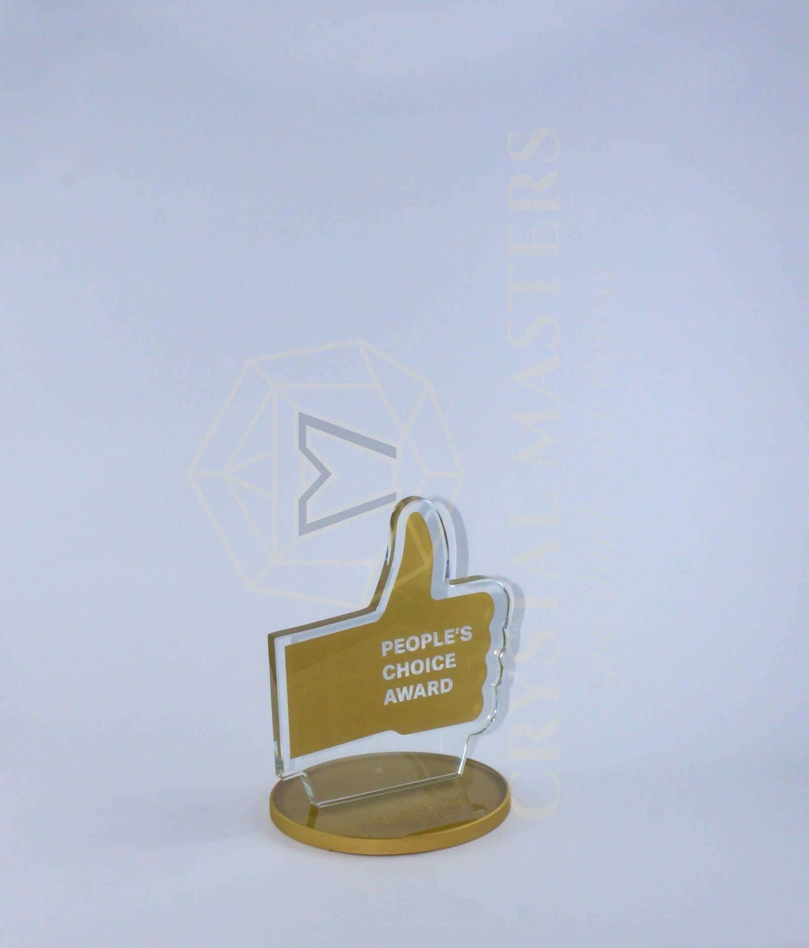 Upright gold-toned thumbs-up silhouette with pale edging on an oval warm-toned base