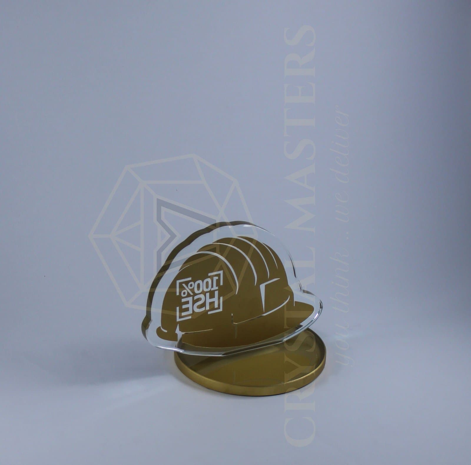 Gold-toned hard-hat-shaped award with front lettering and a rounded display foot