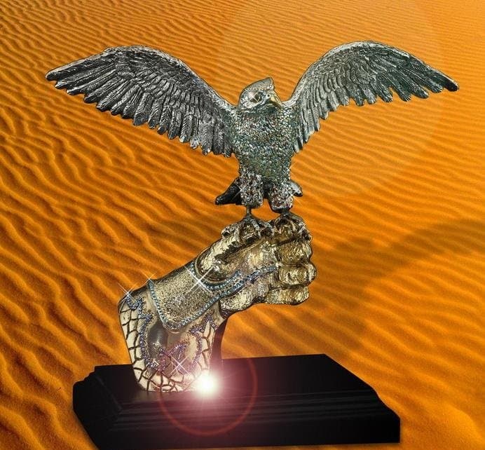 Bird sculpture with spread wings and textured support above a dark rectangular base